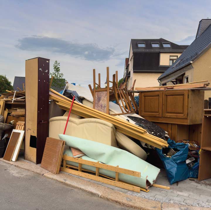 Cleaning up and hauling away a variety of old household appliances for eco-conscious furniture disposal practices in tulare ca